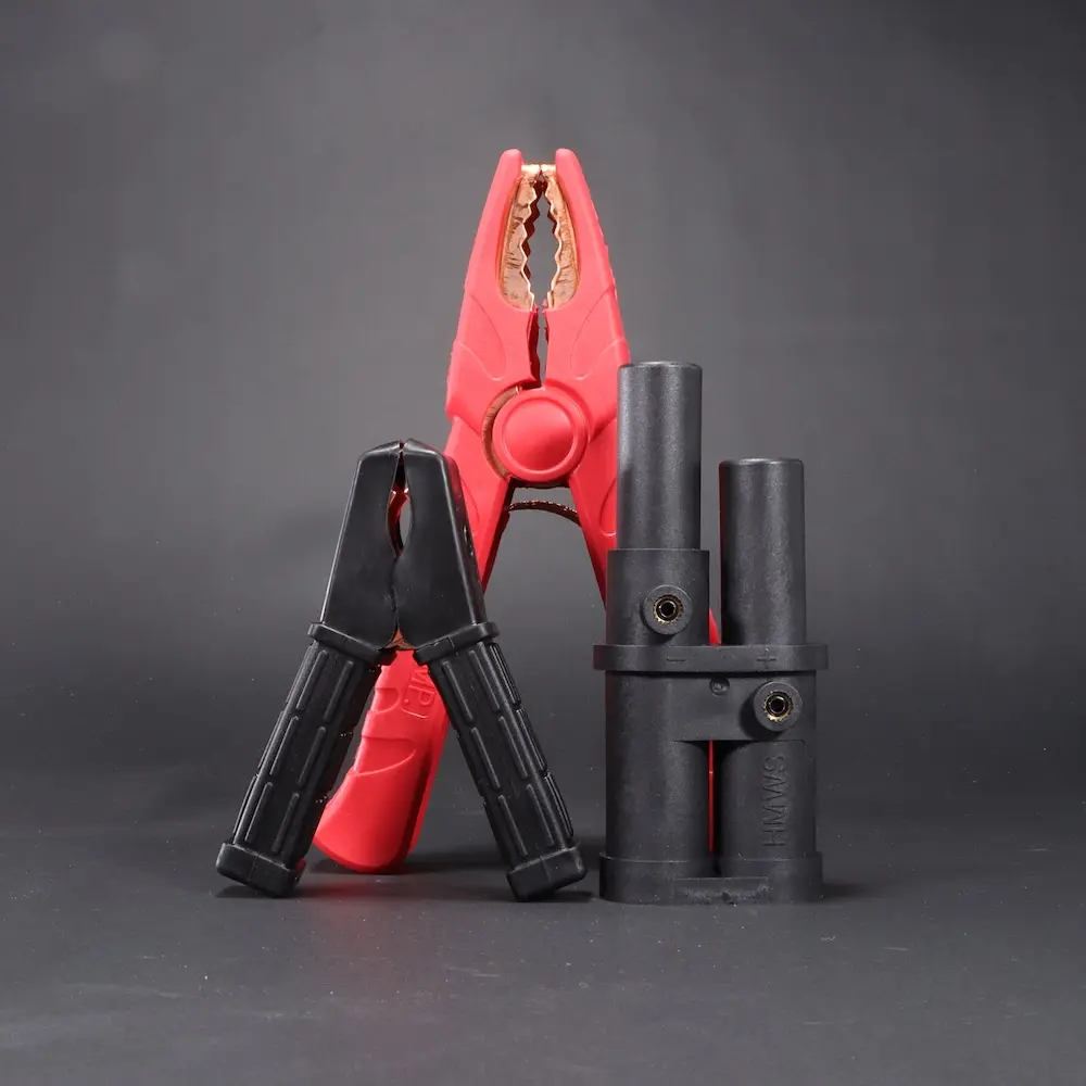 Parts & Bags for jumper cables, including 1000amp positive clamp, 100amp negative clamp, and a J1283 jump start plug. Decorative image.