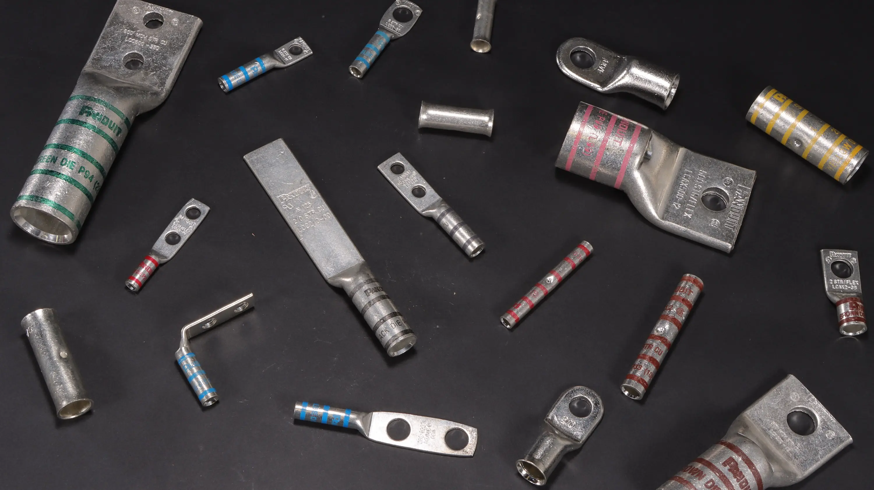 Varoius compression lugs on a dark background scattered. Decorative Image.